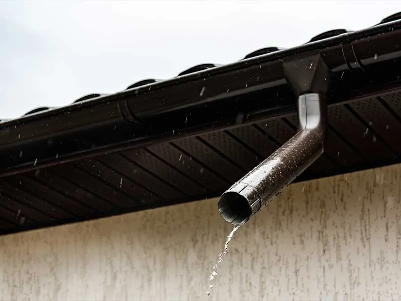 Downspout draining rainwater away from a home