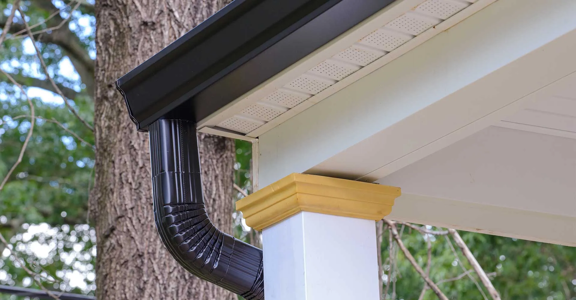 Black seamless gutter and downspout on a porch in Lafayette, LA
