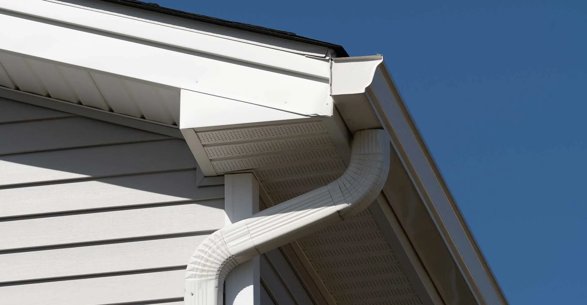 White seamless gutter with downspout in Lake Charles, LA